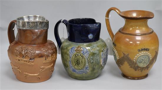 A Royal Doulton George V coronation jug, glazed in blue and green, a Doulton Lambeth four seasons stoneware jug and another jug, appr